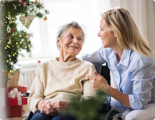 An elderly lady with her caregiver around Christmas time