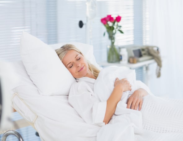 Lady recovering in bed after operation